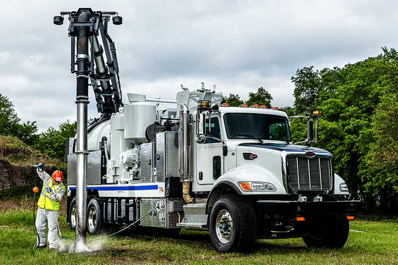 Hydro-Excavator Truck with Worker Using water pressure to dig