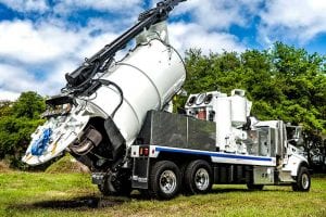 Hydro-Excavator Truck with raised tank dumping load